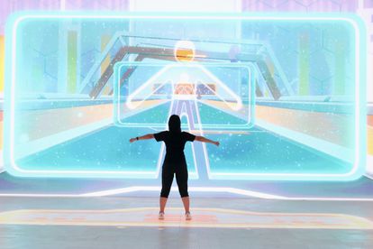 A woman tries out an interactive application at a trade show in Beijing.